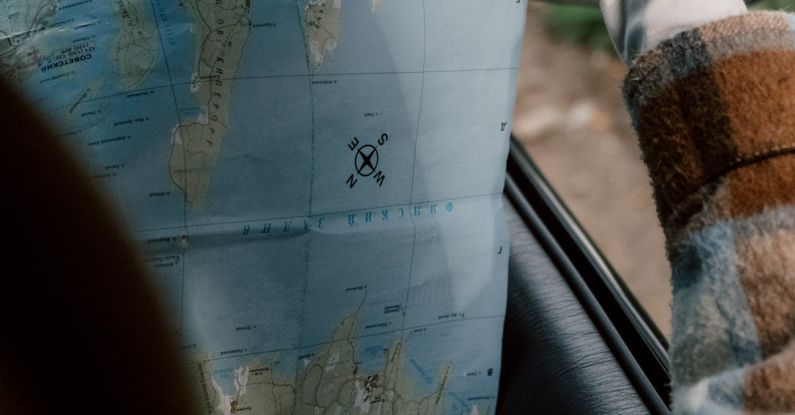 Itinerary - Person in Plaid Long Sleeve Shirt Holding a Map