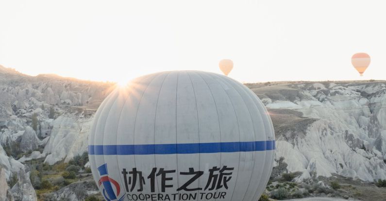 Eco-Tours - A hot air balloon flying over a mountain with the words cappadocia on it